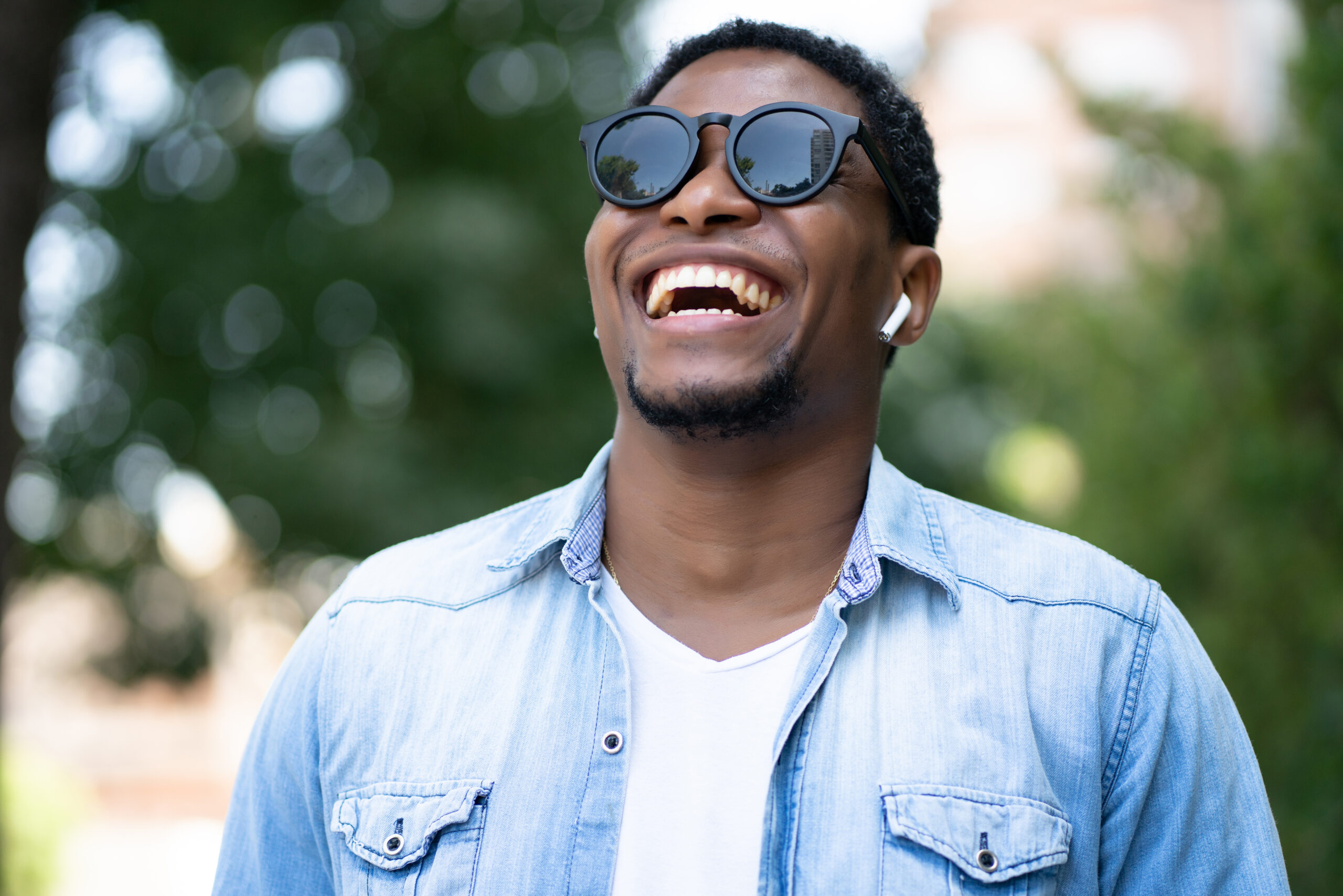 african american man smiling while standing outdoors street scaled