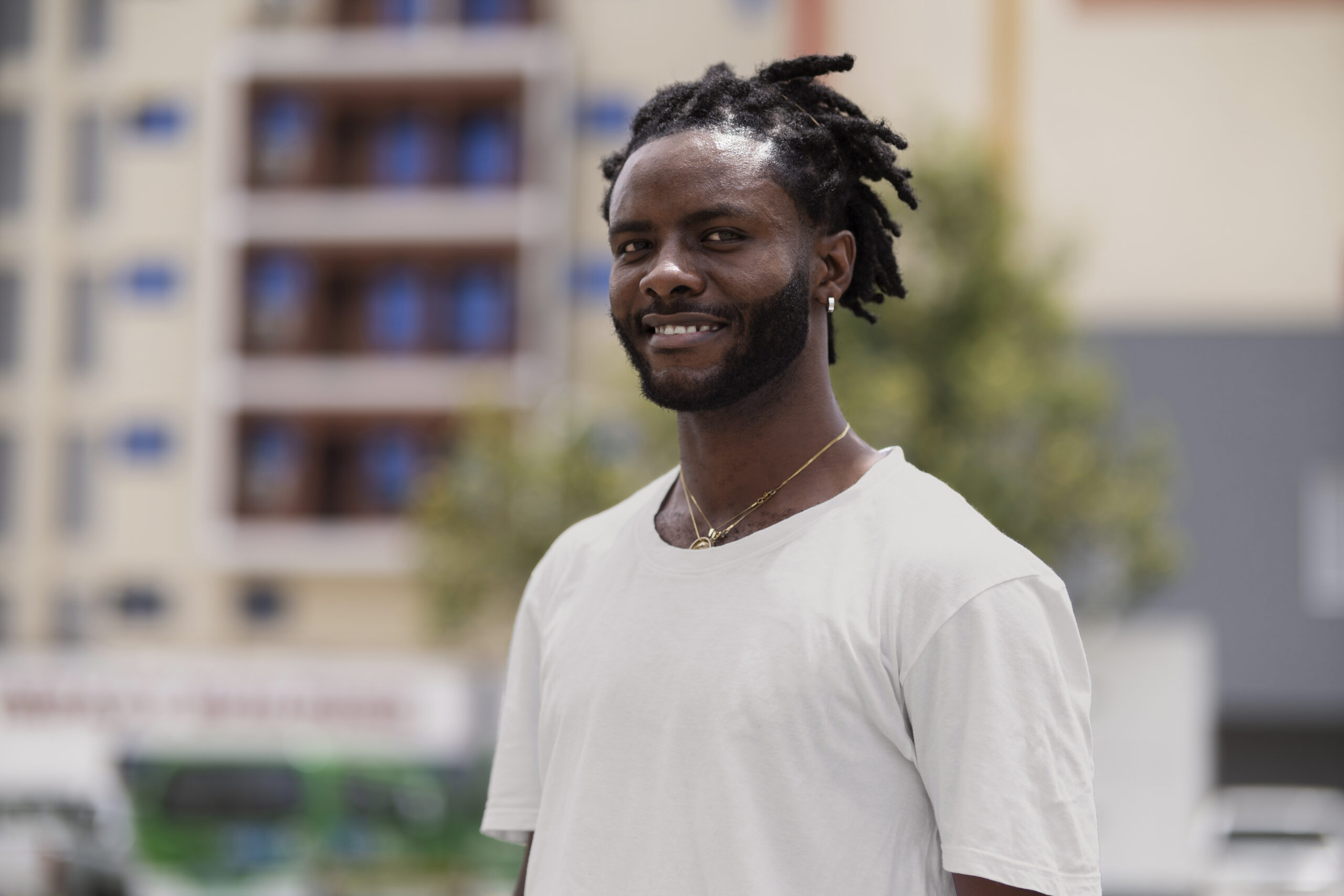 portrait young man with afro dreadlocks white t shirt outdoors scaled