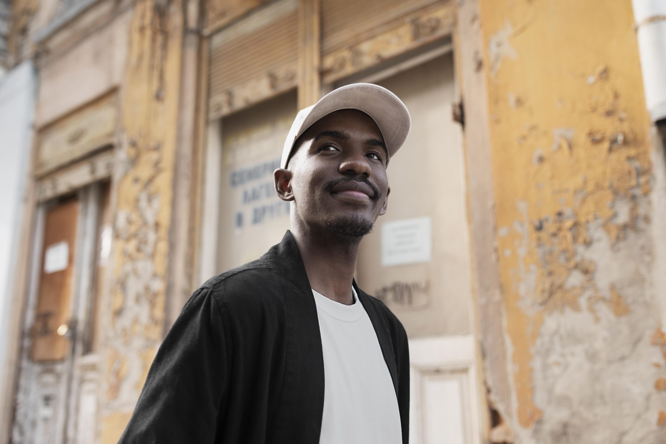 smiley man wearing cap medium shot scaled